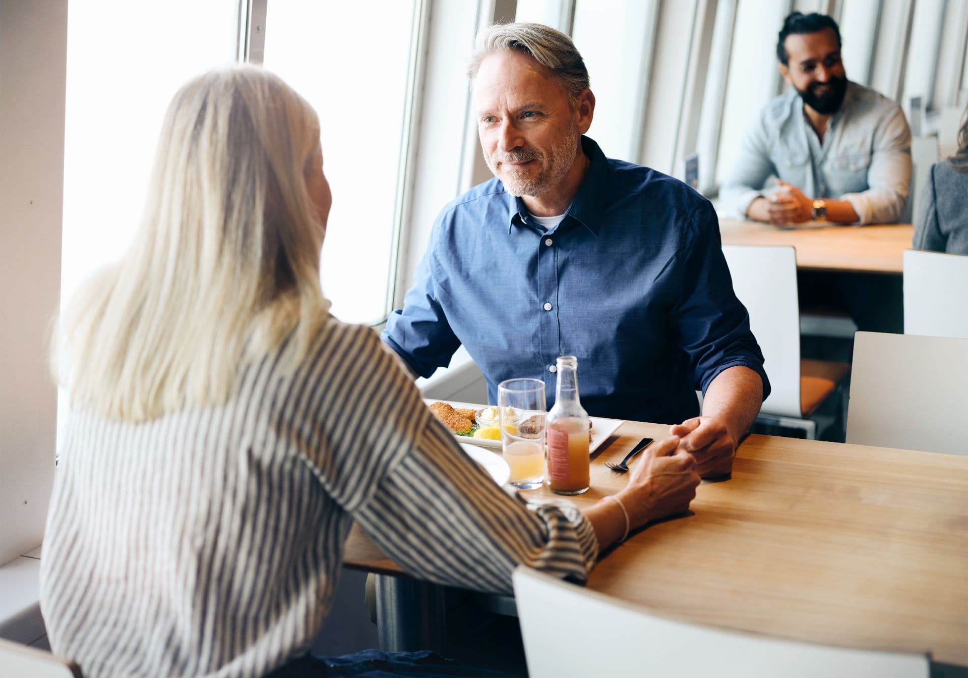 Man and his wife having dinner on the ferry